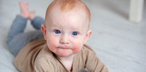 Close-up of a baby’s face with red, irritated skin.