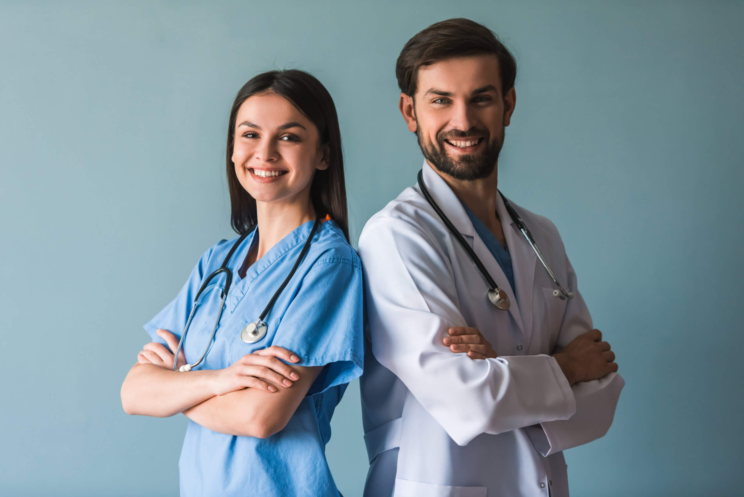 Two physicians standing together in a clinical setting.