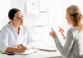 Patient speaking with a clinician during a consultation.