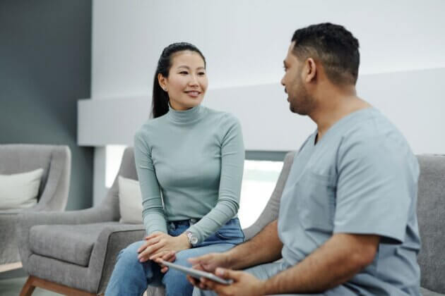 Clinician and patient discussing care with a tablet.