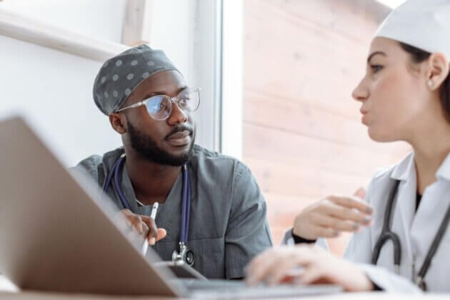 Two healthcare professionals discussing patient care.