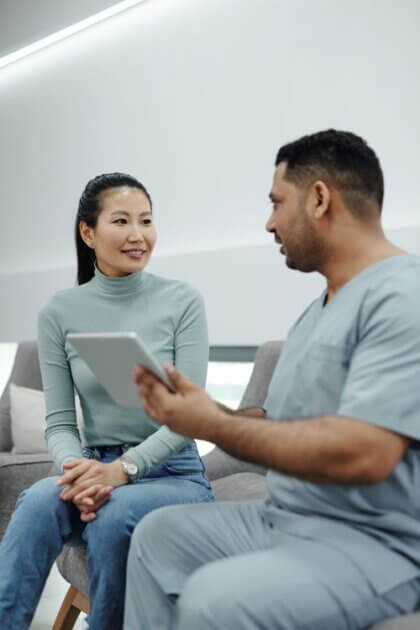 Healthcare provider counseling a patient during a clinical consultation.