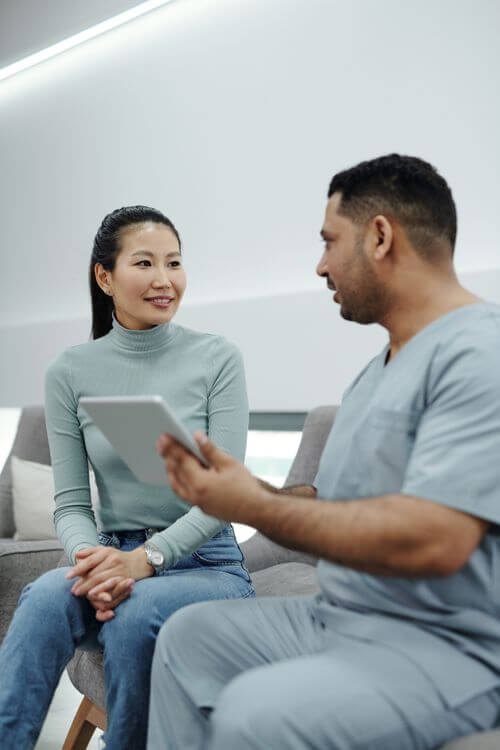 Healthcare provider counseling a patient during a clinical consultation.